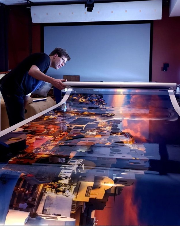 Alex Gubski photographer in his print shop preparing the print for mounting