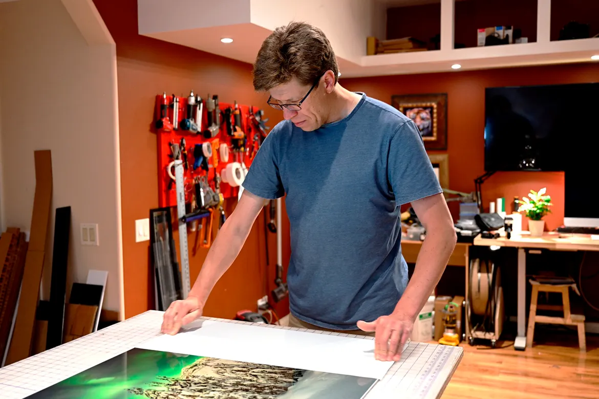 Fine art photographer Alex Gubski hand-crafting a large-format acrylic face-mounted print in his studio