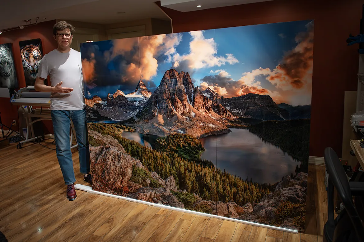 Alex Gubski next to large format mountain photo print