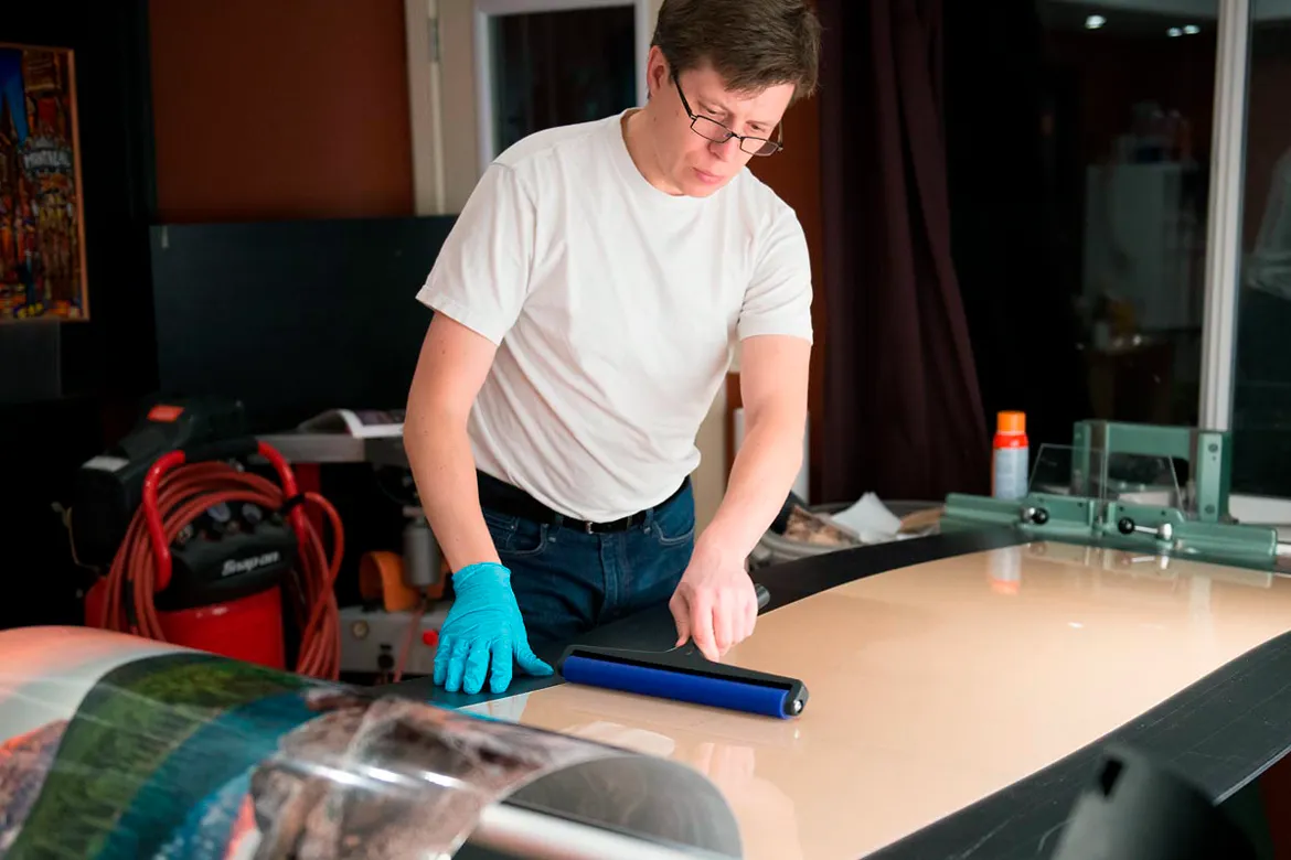 Alex Gubski working on an acrylic acrylic-face-mounted print in his studio